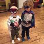 Two young boys dressed up as superheroes.