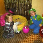 Two children dressed up as mario and luigi