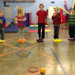 A group of kids playing with an obstacle course.