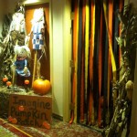 A room with corn stalks and pumpkins on the wall.
