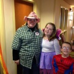 A woman and two children dressed up for halloween.