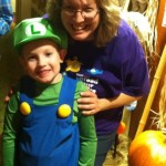 A woman and child dressed up as luigi from mario