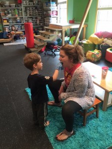 A woman and child in a room with toys.